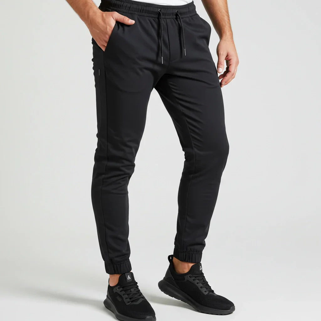 Black tapered joggers from Bearvel’s Performance Joggers Collection, designed with stretch, moisture-wicking fabric, and sleek styling for work-to-workout versatility.